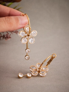 Detailed close-up of 18k gold-plated flower earrings with 5A zircon crystals and hoop closure