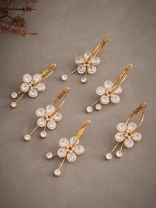 Detail of 18k gold plated flower earrings with 5A cubic zirconia stones and tassels