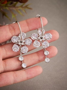 Detailed shot of 5A zircon flower drop earrings with a shimmering silver finish