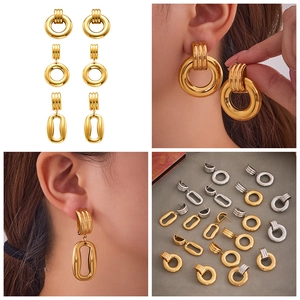 Multiple irregular hollow hoop earrings in gold and silver finishes on a model