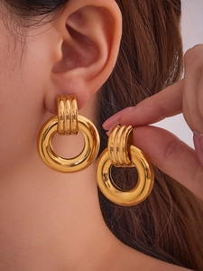 Close-up of minimalist 18k gold plated hollow double-ring hoop earrings worn by a model