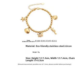 Detail view of gold ocean charms including starfish and shell on stainless steel bracelet