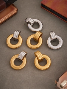 Detailed view of irregular hollow hoop earrings with thick 18k gold and silver plating
