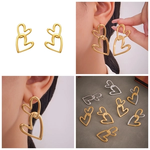 Detail view of interlocking heart earrings in gold and silver finish with model display
