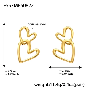 Macro view of gold plated double heart drop earrings with detailed size measurements