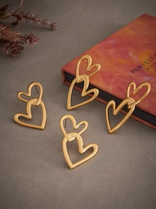 Detailed view of interconnected double heart earrings with a polished 18k gold finish
