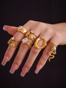 Detailed view of 18k gold plated stainless steel ring set with 5A zircon on black knit fabric