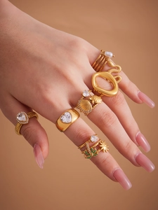 Close-up of a 18k gold plated stainless steel ring set with zircon and heart charms