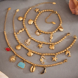 Set de pulsera de acero inoxidable dorado con dijes marinos de estrella de mar y circonitas