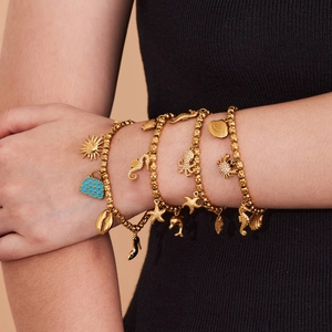 Golden beaded ocean charm bracelet set featuring octopus starfish and zircon details