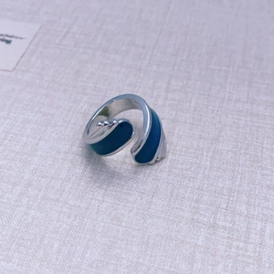Silver open ring featuring dark blue enamel in a modern asymmetric wave design