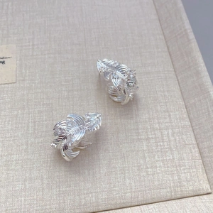 French style feather earrings in S925 silver with sparkling zircon stones in a jewelry tray
