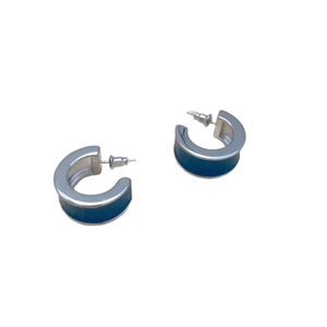 Modern C-shaped hoop earrings featuring silver metal and deep blue enamel inlays