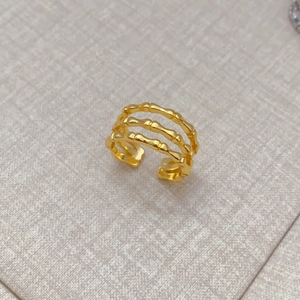 Detailed view of the triple-layer bamboo texture on this gold-plated open ring