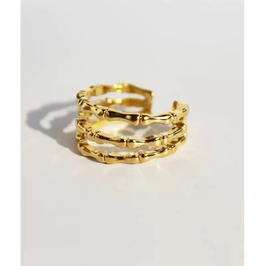 Macro shot of 18k gold-plated triple-layer bamboo textured adjustable open ring