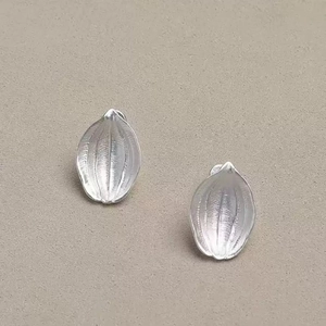 Vintage pomegranate seed studs in silver leaf shape with elegant gold textured finish