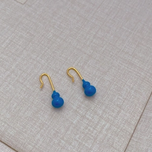 Minimalist gold ear hooks with bright blue enamel gourd pendants in a modern style