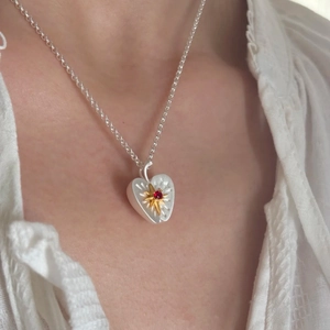 Chic heart-shaped apple pendant necklace with red gemstone and golden sunburst details