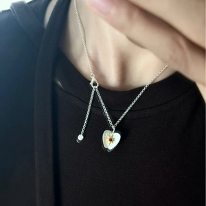 Fashionable bicolor silver and gold heart pendant necklace with starburst detail for women