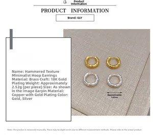 Detail of 18K gold-plated brass hoop earrings featuring a unique hammered texture design