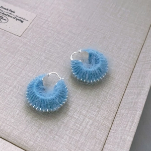 Ethnic sky blue hand-woven yarn hoop earrings with silver beaded trim for women