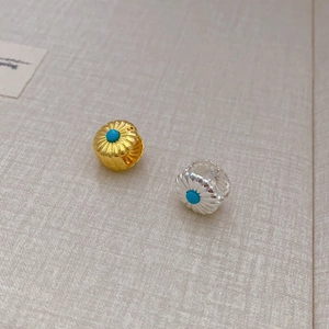 Double-sided sunburst stud earrings with turquoise inlay in gold and silver finish