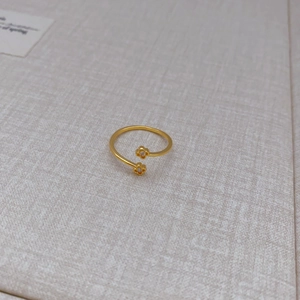 Minimalist gold-plated open ring featuring two small flowers with diamond accents