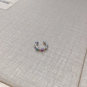 Minimalist silver ear cuff featuring vibrant multi-color gemstones in a C-shaped design