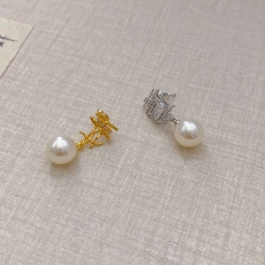 Fashionable gold and silver drop earrings featuring pearls and sparkling zircon accents