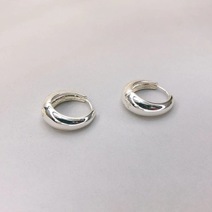 Polished silver oval hoop earrings for women with high-shine metallic mirror finish