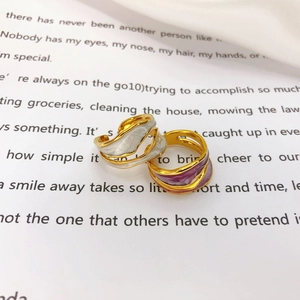 Detail of irregular wavy gold-plated open rings with white and purple enamel drip oil