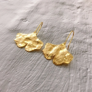 Elegant gold ginkgo leaf dangle earrings with a hand-hammered texture finish