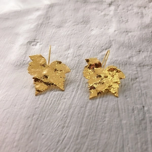 Elegant 18K gold plated leaf earrings with textured hammered finish on a clean white backdrop