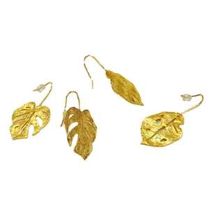 Retro 18K gold plated monstera leaf earrings with hammered texture on white background