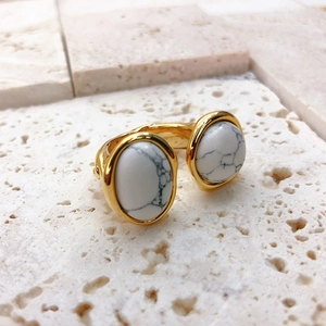 French style open ring with gold metal finish and two white marble stone inlays