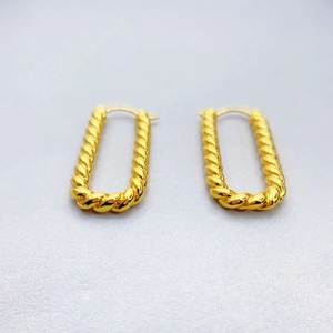 Macro detail of 18K gold plated rope twist earrings with textured rectangular design