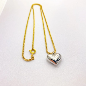 Two-tone heart pendant necklace with gold chain and polished silver 3D heart