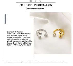 Detail of 18K gold plated copper ring with sparkling zircon and double ball design