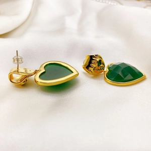 18K gold plated heart earrings with emerald green stones on elegant white satin