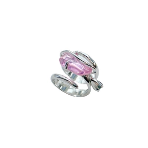 Adjustable silver brass ring featuring an irregular pink crystal stone on white background