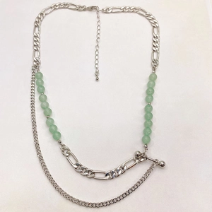 Fashionable layered silver chain necklace with green aventurine beads on white backdrop