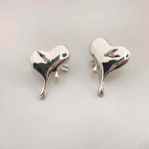 Polished silver heart and arrow stud earrings with a surrealist lava dripping design