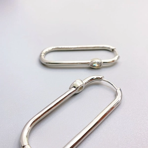 Silver oval paperclip earrings with teardrop cubic zirconia and sleek polished finish
