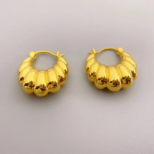 Detailed macro view of 18K gold plated chunky hoop earrings with spiral croissant design