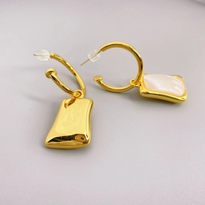 Gold hoop earrings with shell inlay and rectangular pendants in minimalist geometric style