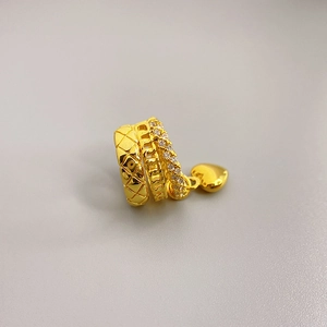 Gold 18K plated ear cuff featuring quilted patterns, crystal pavé, and a heart pendant