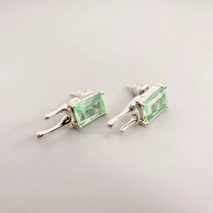 Minimalist liquid metal stud earrings with emerald green rectangular gemstone