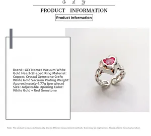 Macro detail of platinum-plated heart ring with red crystal and adjustable band