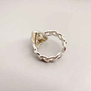 Silver chain-link ring featuring a heart-shaped centerpiece and adjustable open band design