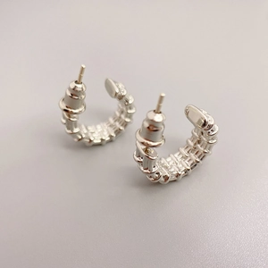 Polished silver C-shaped hoop earrings with intricate hollow woven texture and S925 pin